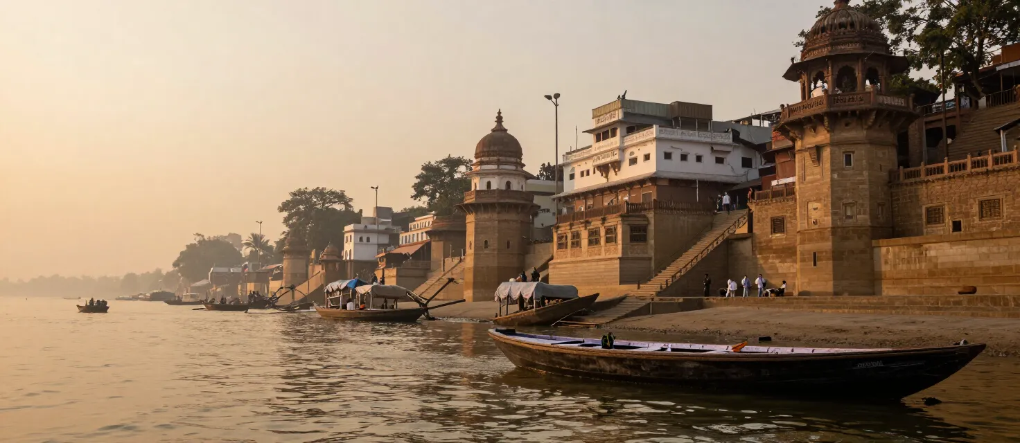 Wooden boat on the Ganges beside the historic ghats of Varanasi at sunrise